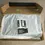 Thumbnail: Top view of the shoes wrapped in tissue in the open box