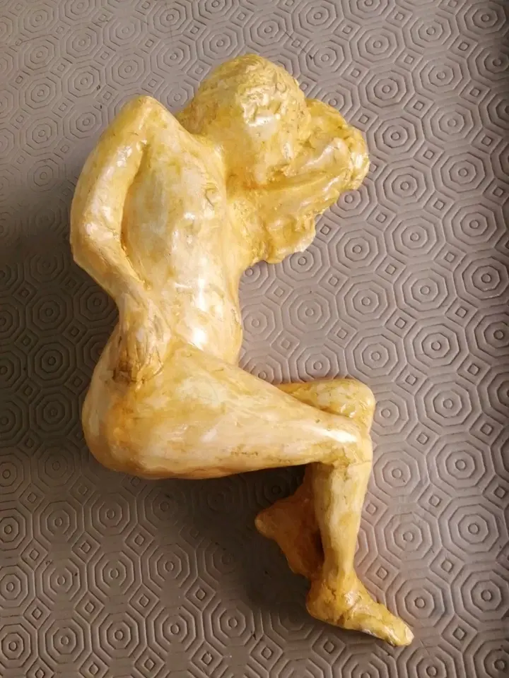 Top view of the Studio Art Of A Nude Woman Figure Lying Down in an orange glaze