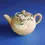 Thumbnail: Stylised side view of the Japanese Banko Pottery Teapot with white flower and green leaves design