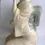 Thumbnail: Left side view of the Japanese Guisha Girl Figurine kneeling with a red flower in her hair