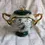 Thumbnail: Front view of the Beauties Of The Red Mansion 6th Edition Heir Loom Green Porcelain Music Box