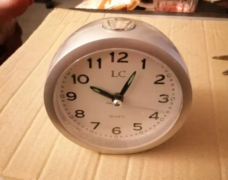 Angled front view of the LC Silver Alarm Clock Sweeping Second Hand Quiet Tick