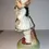 Thumbnail: Left side view of the Hummel Style Figurine Little Girl Holding Flower Basket