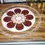Thumbnail: Zoomed in photo of the wooden board and ceramic disc