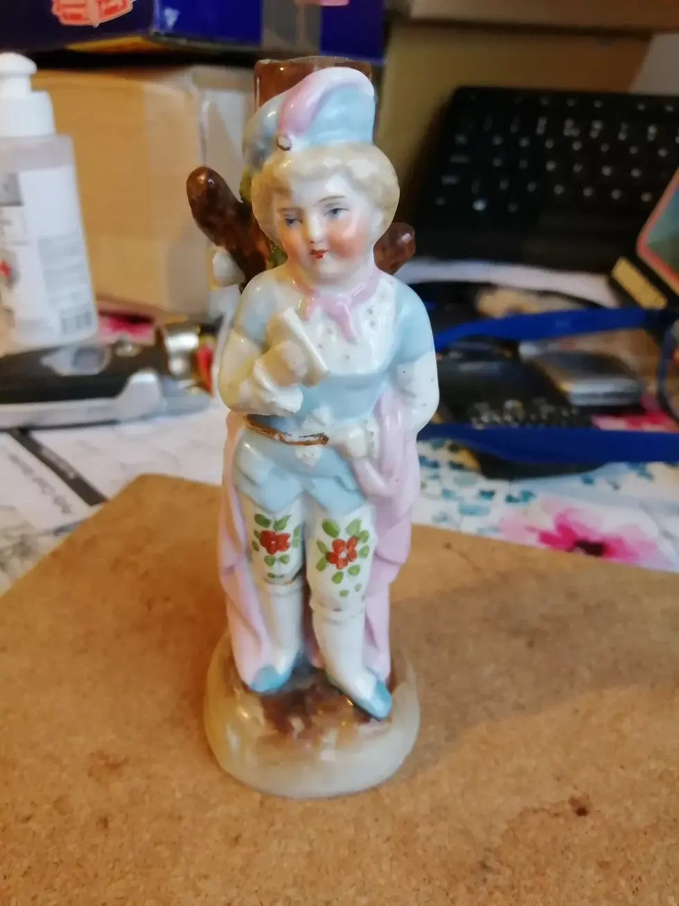 Front view of the Conte German Boy Leaning against a Tree Figurine
