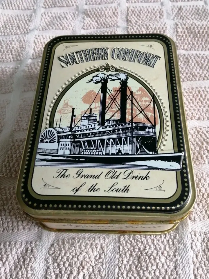 Top view of the Southern Comfort Tin With a Steamboat Design on the lid