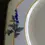 Thumbnail: Close up of the Small blue flower detail on the left side of the plate