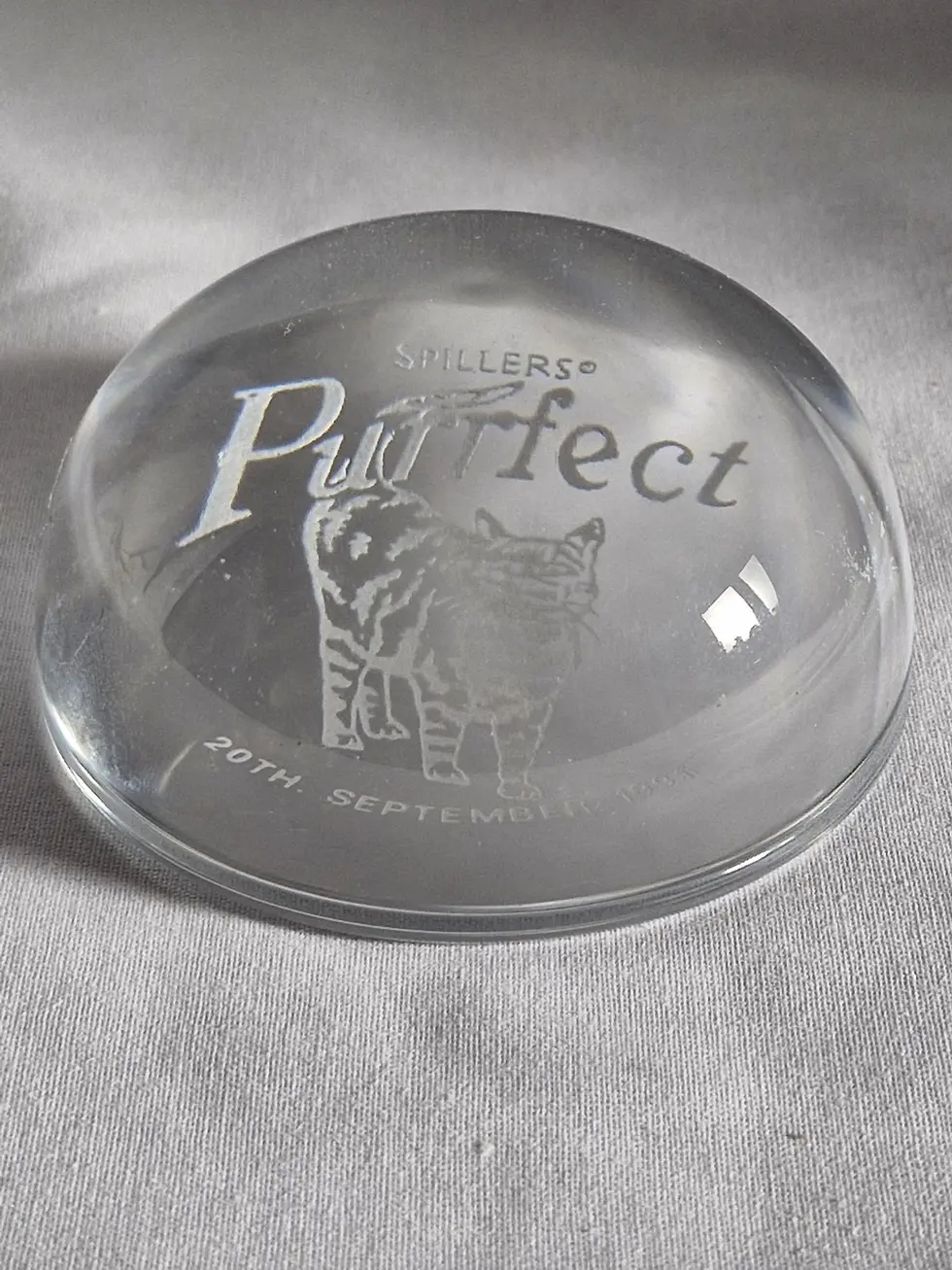 Front view of the Spillers Purrfect Commemorative Clear Glass Paperweight With Cat Design and text