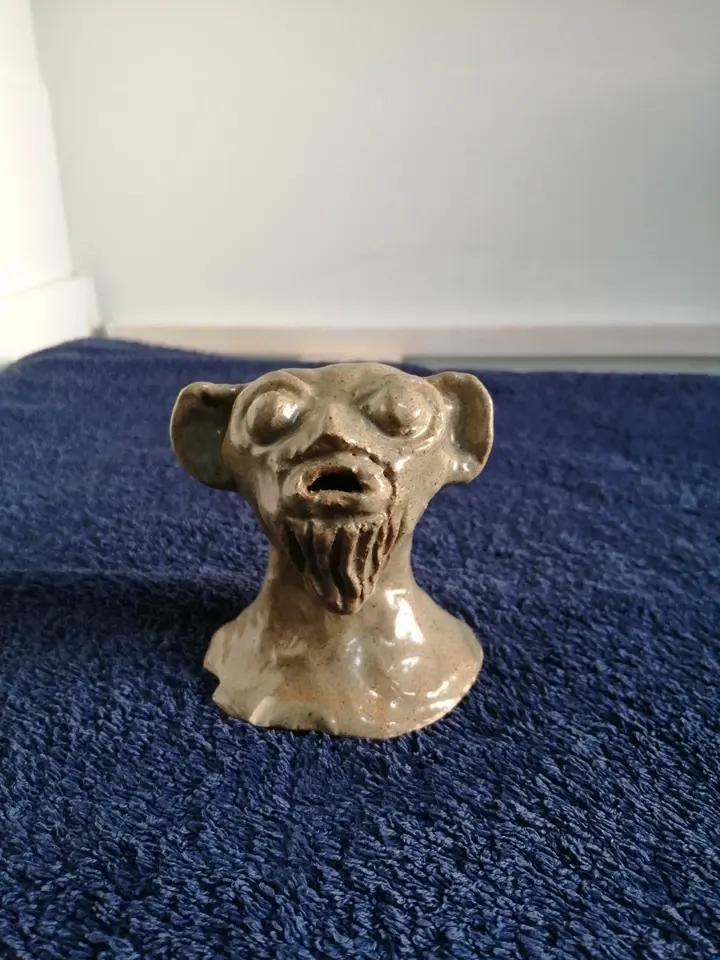 Front view of the Studio Art Light Brown Figure Head Of A Mythical Creature
