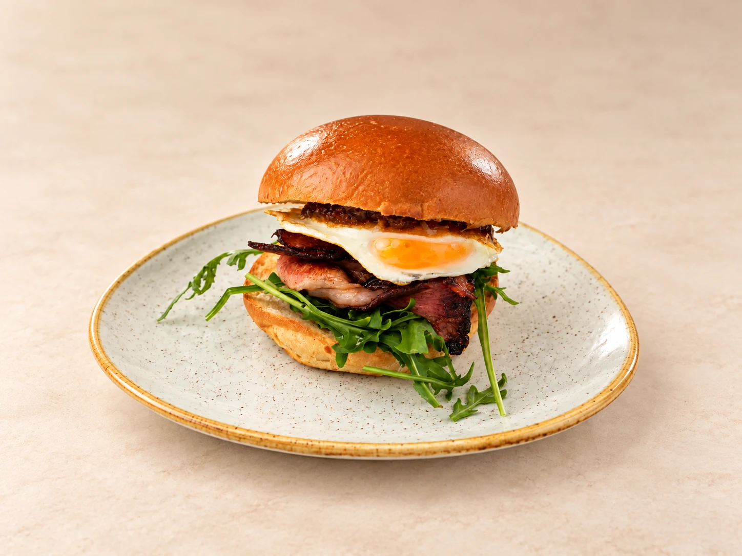 Bacon and egg roll on a fully visible plate
