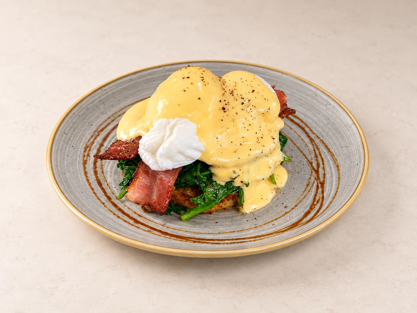 Eggs Benedict with bacon on a fully visible plate