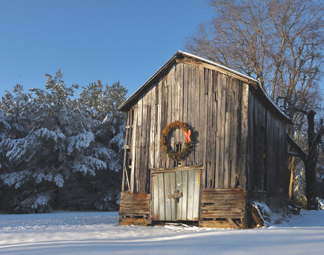 old grey barn with Christmas wreath, snow 