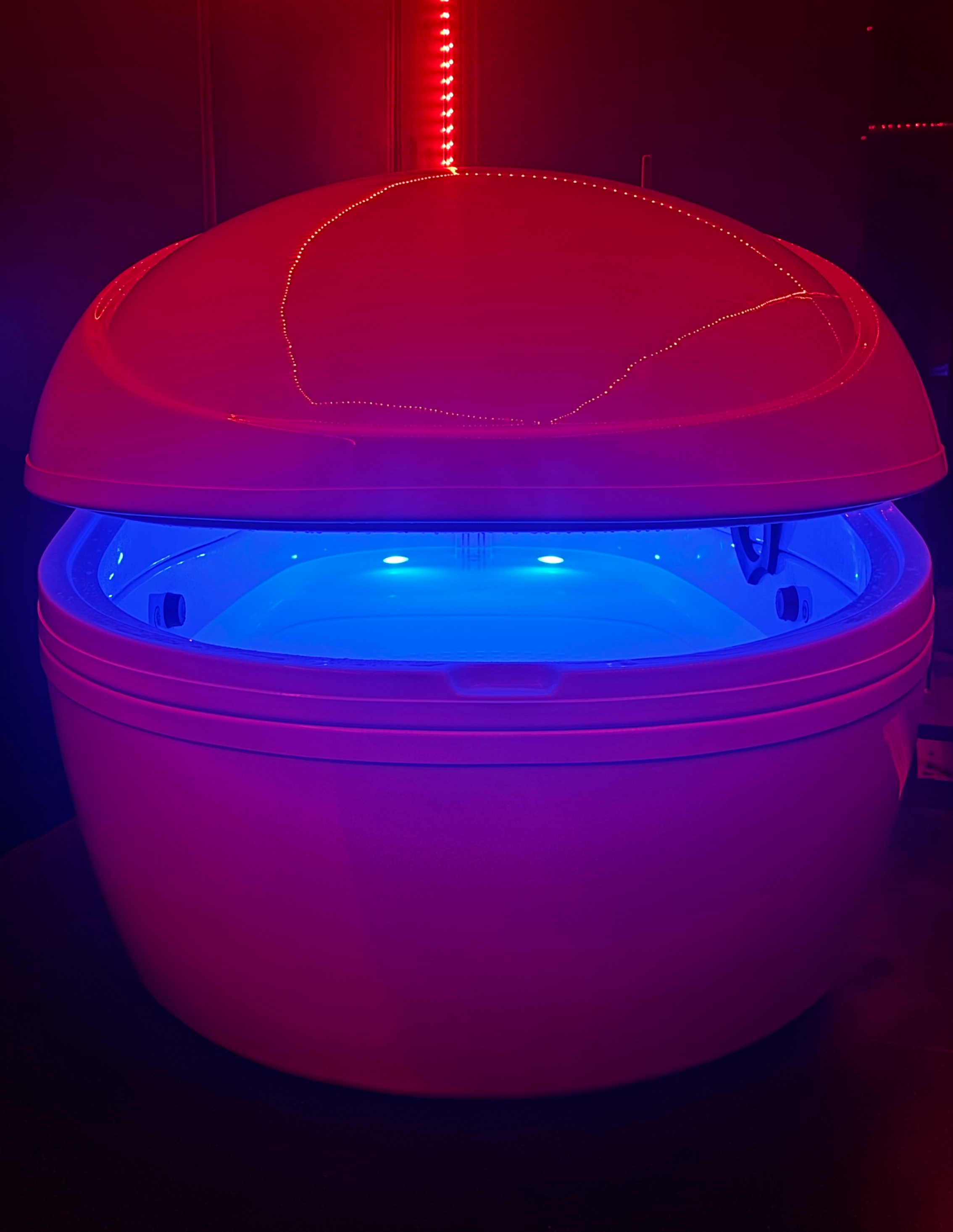 A clean, private sensory deprivation tank room at our Bristol studio, helping clients naturally manage chronic pain and ease joint load.