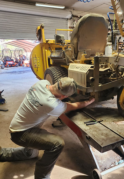 Certified Mechanic repairing a Walker Mower under warranty