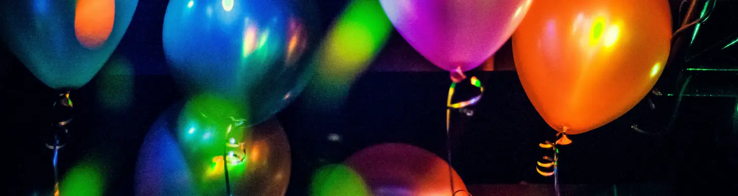 Colorful illuminated balloons at party