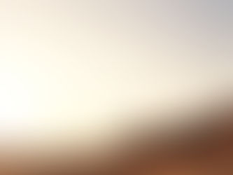 A lone figure walks across a vast desert landscape at sunset, with towering rock formations and clear skies in the background, evoking serenity.