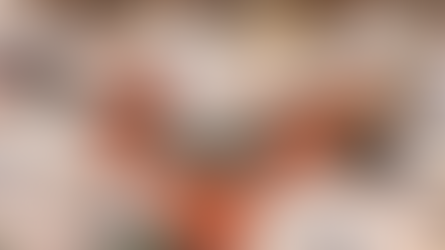 Inmates in white uniforms labeled "Alabama Dept. of Corrections" sit on mats in meditation. A person in civilian clothes leads the session.