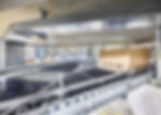 The approximately 250-m long central ring conveyor from Arvato SE was extensively modernized using PC-based control, One Cable Automation, and around 200 EP box modules for roller drives. © Beckhoff