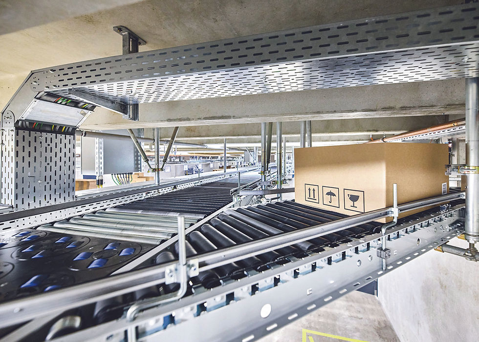 The approximately 250-m long central ring conveyor from Arvato SE was extensively modernized using PC-based control, One Cable Automation, and around 200 EP box modules for roller drives. © Beckhoff