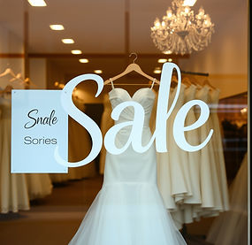 Window of a bridal shop with a sign _Sale_ on a window.jpg