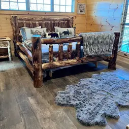 king sized bed hickory carved faux bearskin rug woodgrain porcelain tile knotty pine wall siding banditlodge
