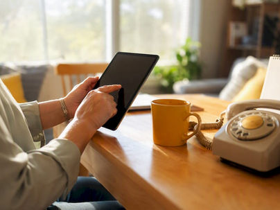 Agency coordinator hands using tablet and phone headset