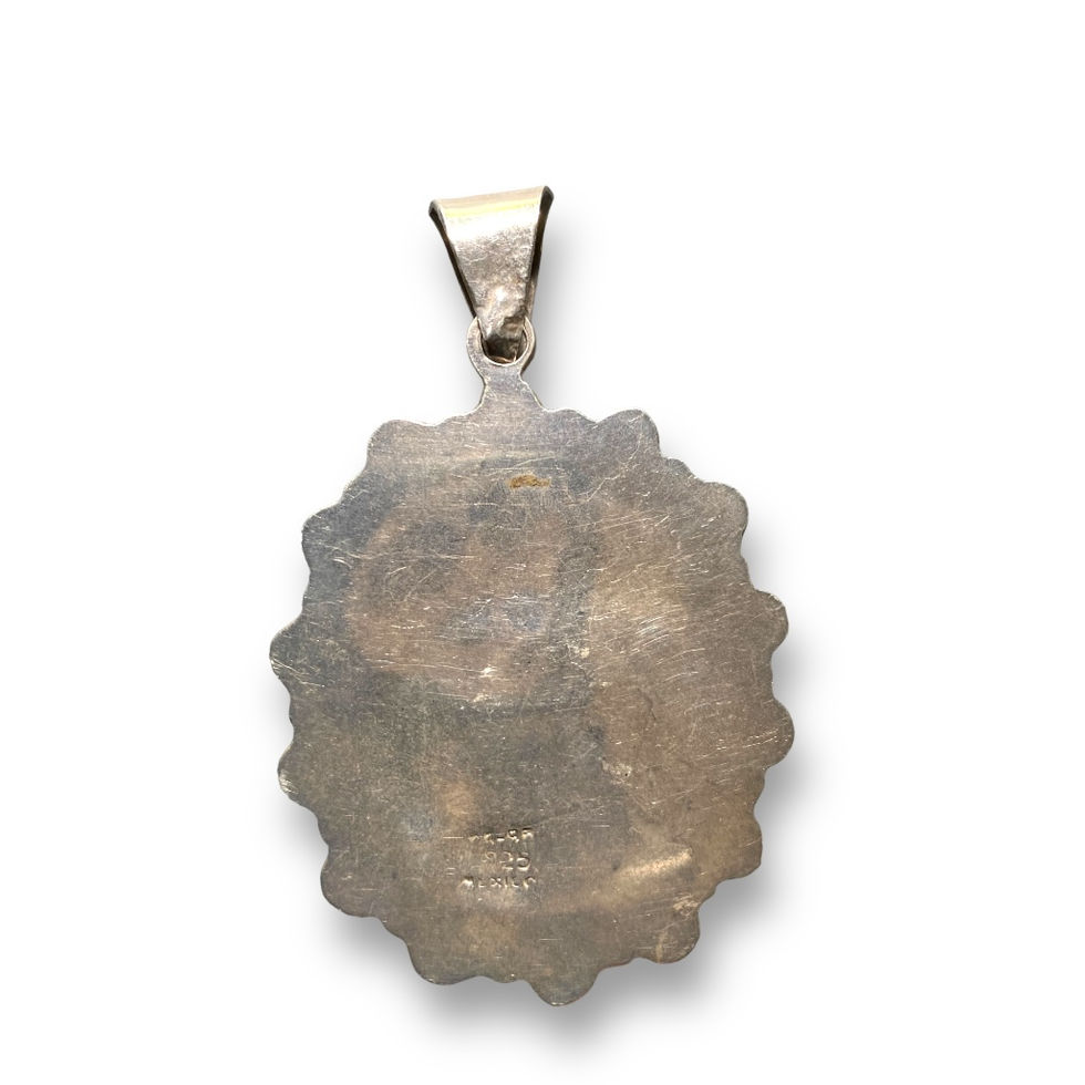 back view of silver pendant with blue stone