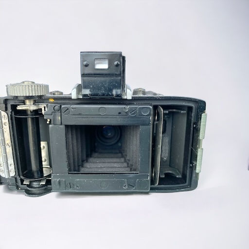 compact sleek black camera with silver accents and pull out lens