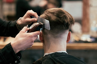 Man getting a skin fade at barbers using clippers.jpg