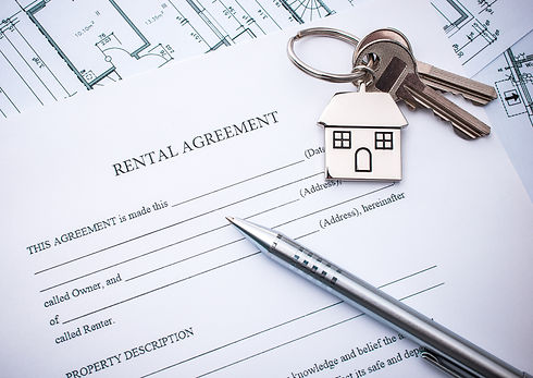 Rental agreement contract with pen and keys on top