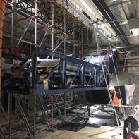 Escalator sat on blue metal platform