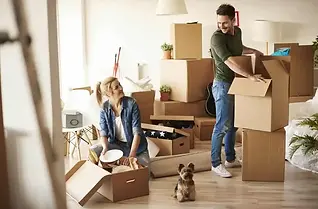 A couple packing boxes to move home