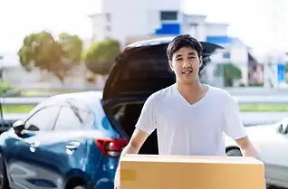 Young man carrying a box