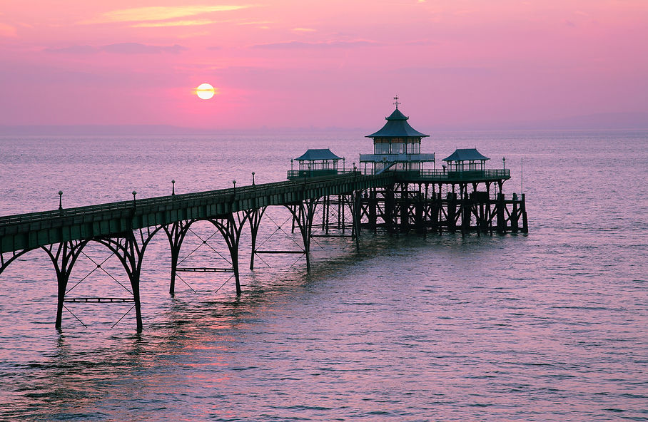 Sunset over Clevedon Pier, a unique and fully intact Grade I listed pier, in the North Som
