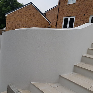 White, rendered garden steps and wall