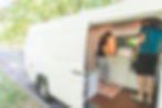 couple preparing meal in a campervan