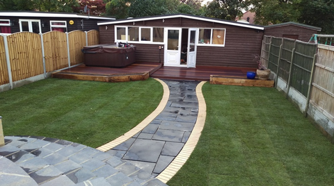 neat and tidy back garden with path leading to summer house