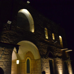 The exterior wall of the building is lit at night