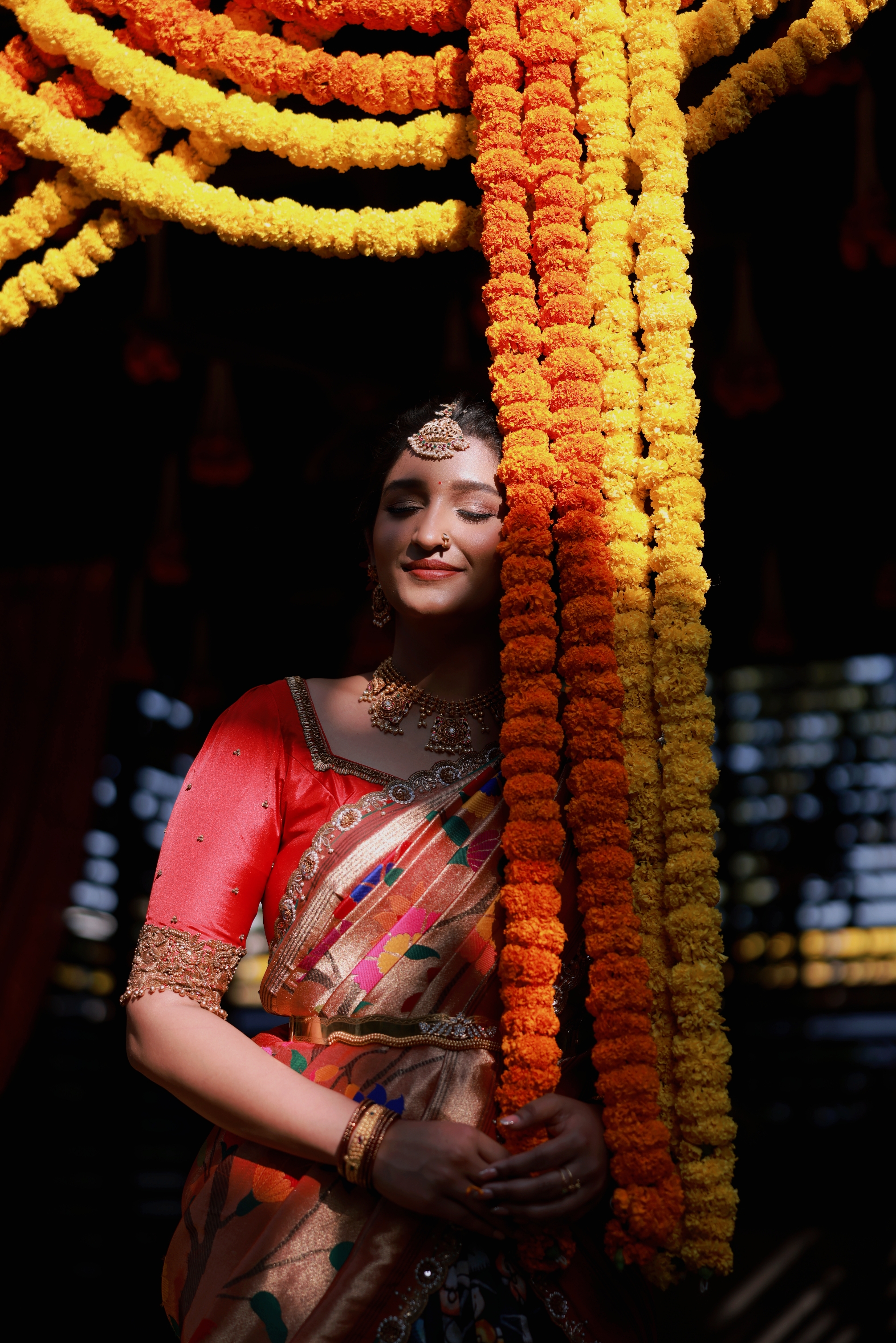 Bride in saree among marigold garlands — brides' favourite photographer Sujay Naidu, Minchu Productions Bangalore