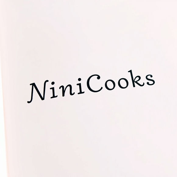the name NiniCooks small and many times typed on the page and pastel pink.jpg