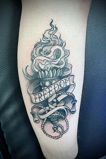 a tattoo on a leg that says freedom