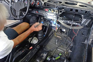 Posche interior being serviced by George Perdomo with him making repair to dashboard