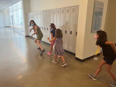 Kenz creeping through hallway with campers.jpeg