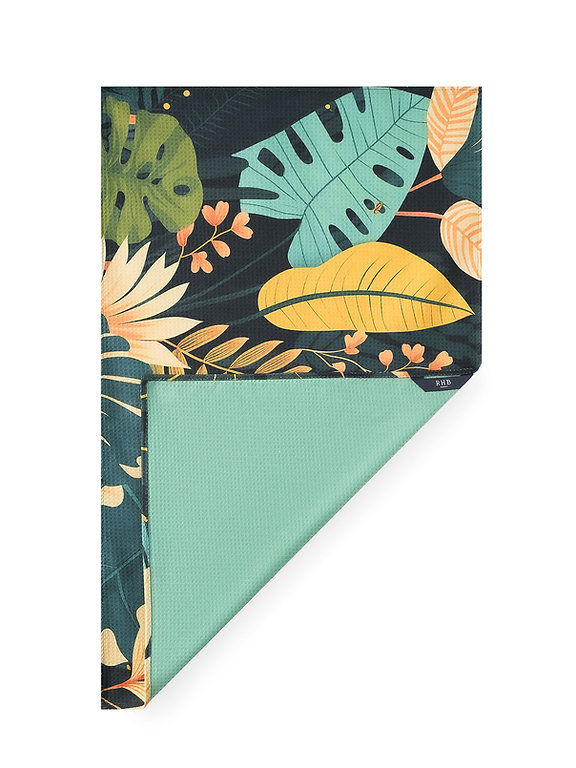 Lau kitchen tea towel with tropical leaf print in mustard, beige, and blue tones and solid mint green back.
