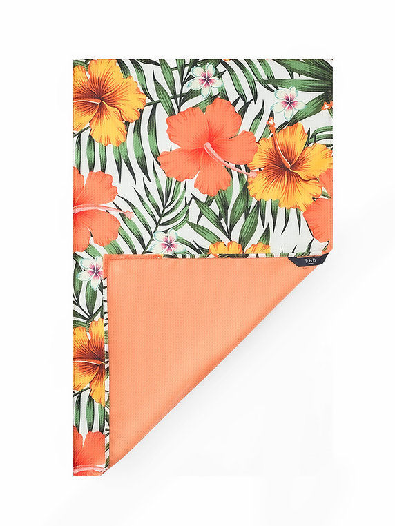 Hawaii Hoku kitchen tea towel with orange floral and tropical leaf print and solid orange back.