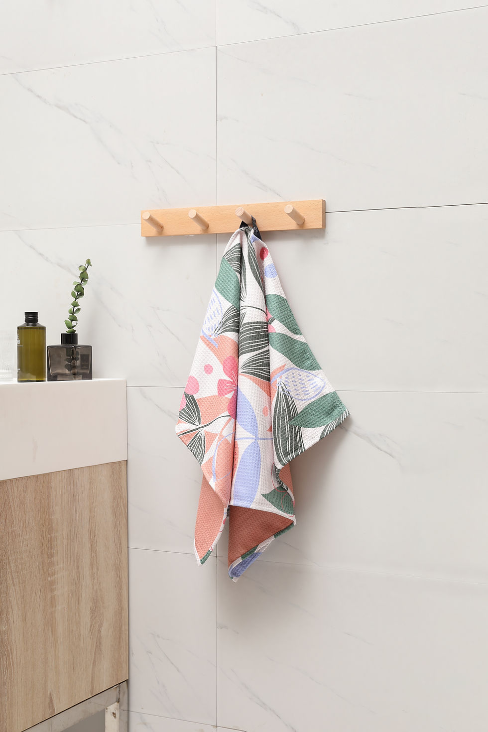Thumbnail: Party of Flowers kitchen tea towel hanging on a wooden hook.