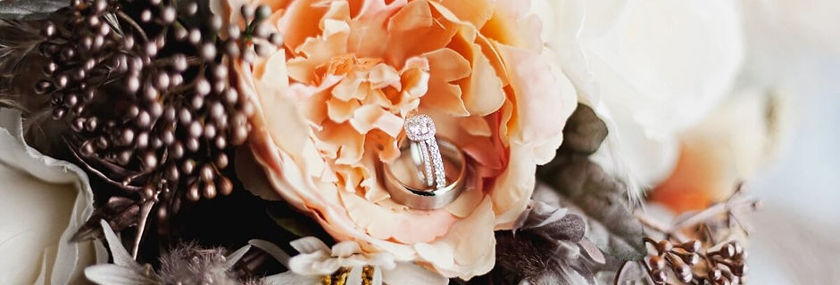 Wedding bands resting on floral details, photographed for an intimate Los Angeles wedding by Captured by Angela Tayler.