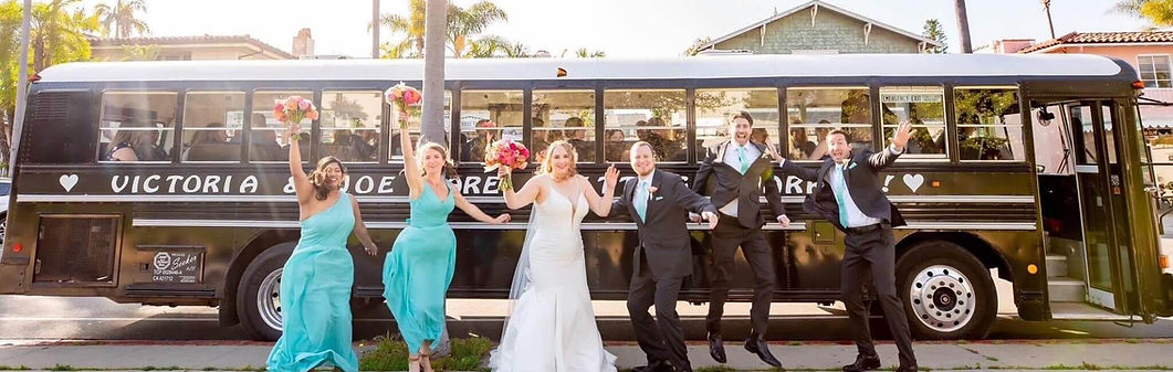 Wedding party celebrating in front of a yellow school bus from Jump On The Schoolbus, Santa Barbara wedding transportation