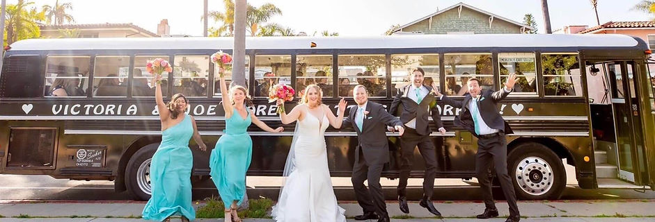 Wedding party celebrating in front of a yellow school bus from Jump On The Schoolbus, Santa Barbara wedding transportation