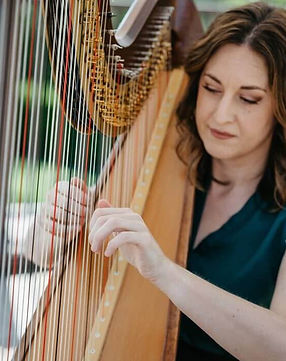 Wedding harpist Lauren Sharkey from Sacramento. beside her harp. Known for creating elegant and romantic live music experiences.